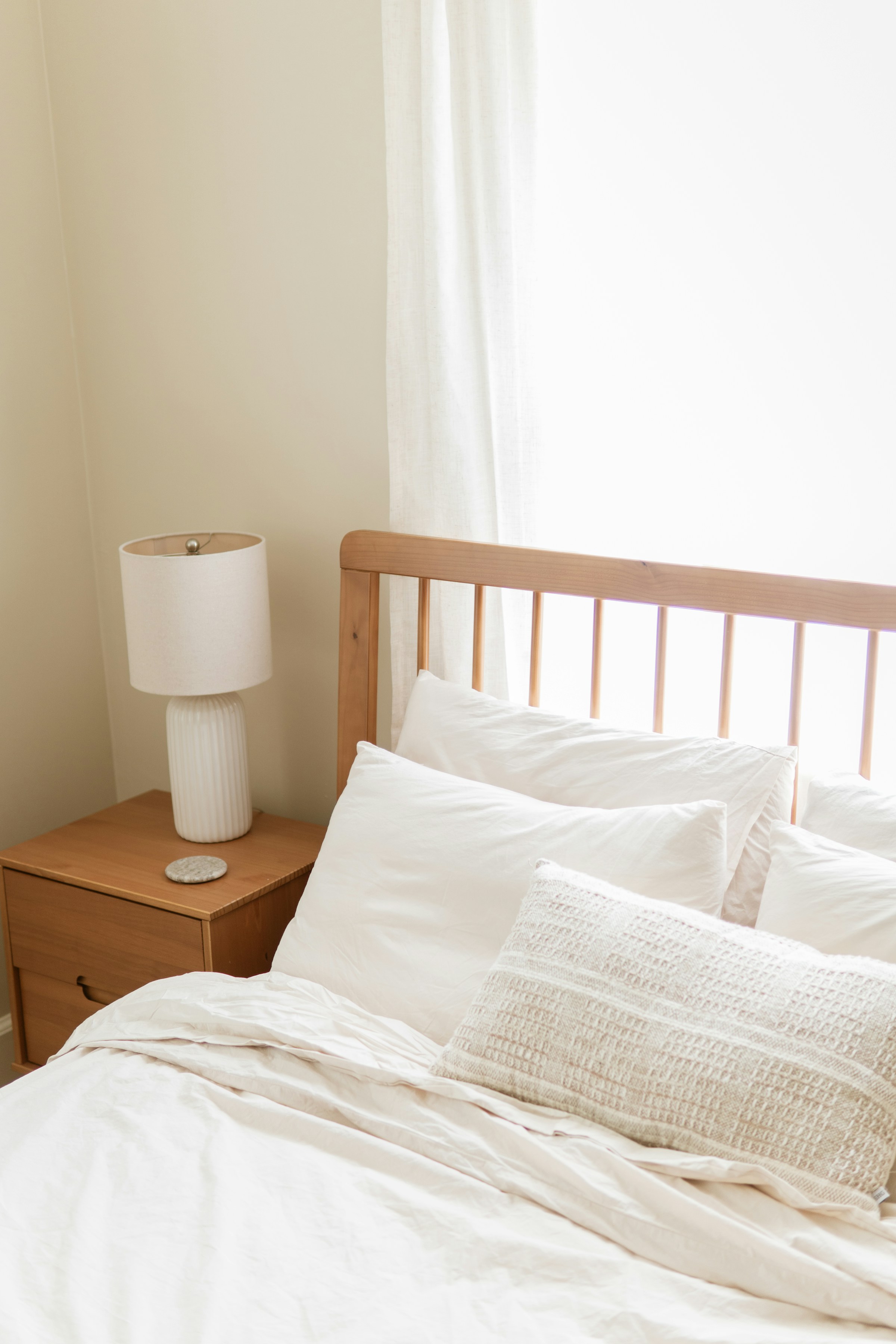 Calm bedroom with natural linen bedding, soft light, low contrast